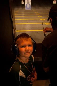 Boy at Shooting Range with Teacher Stock Photos