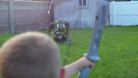 Boy shoots archery bow at goblin target and misses Stock Footage 171996595