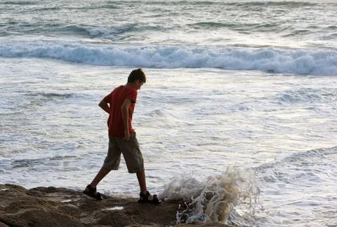Boy on the shore Stock Photos