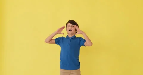 Boy shouting with hands cupped Stock Footage 145236040