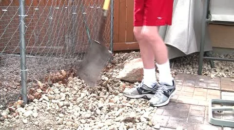 Boy shovel rocks 1 Stock Footage 10833055
