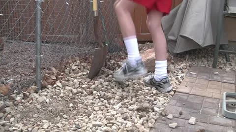 Boy shovel rocks 2 Stock Footage 10833214