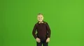 The boy show a circle on the green background 4k or 4k+ Resolution