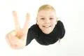 The boy show two finger to the camera. View from above Photo