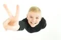 The boy show two finger to the camera. View from above Photo