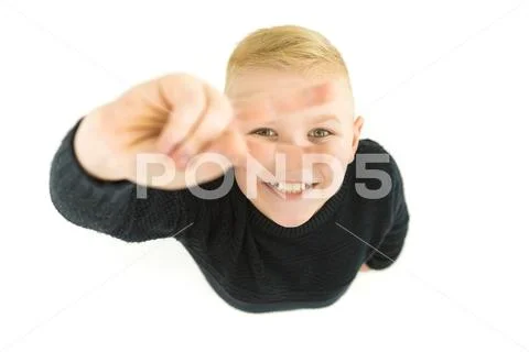 The boy show two finger to the camera. View from above Stock Photos