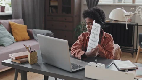 Boy Showing Notes on Computer Camera Stock Footage 169461521