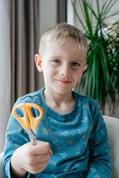 Boy showing scissors smiling Photos