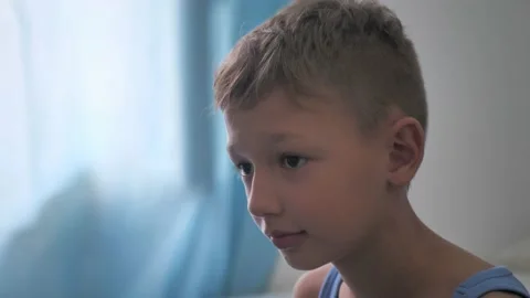 Boy shows his tongue while playing games Stock Footage 220597009