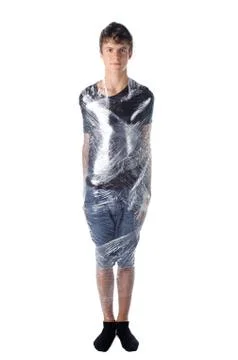 Boy shrinkwrapped on cellophane Stock Photos