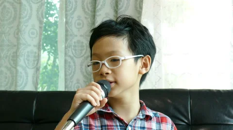 Boy sing a song at home Stock Footage 64834646