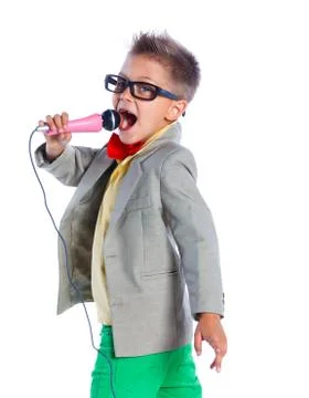 Boy singing with a microphone Photos