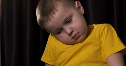Boy sit on bed, tablet on lap, close-up, rests head on shoulder, child, device Stock Footage 126307839