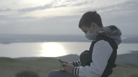 A boy sits and plays a tablet Stock-Footage 141758371