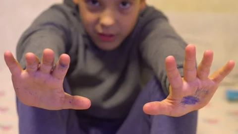 The boy sits and stretched out his hands 4K Video stock 219404541