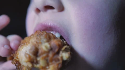 Boy sits in cafe and eats fast food. Fried chicken. close up Video stock 142985937