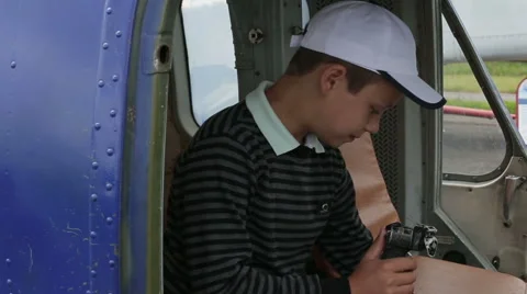 The boy sits in the cockpit of the helicopter at the helm Stock Footage 65188071
