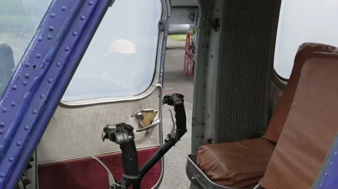 The boy sits in the cockpit of the helicopter at the helm Stock Footage 65564293
