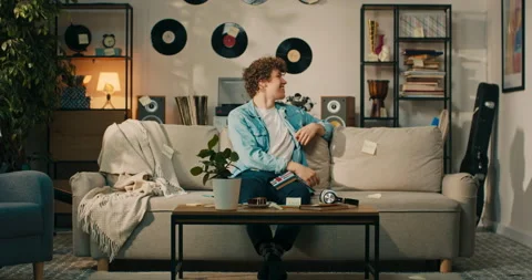 A boy sits on the couch and learns a foreign language. Cards with words are Stock Footage 218232345