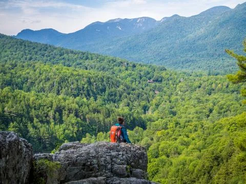 Boy sits at the edge of the cliff Stock Photos