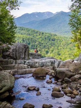 Boy sits at the edge of the cliff Stock Photos