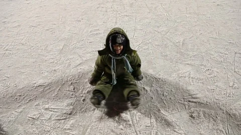 The boy sits on the ice and smiles Stock Footage 59142711