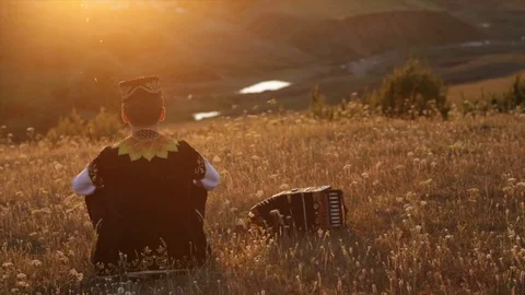 The boy sits in the sunset Stock Footage 100324617