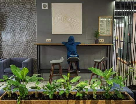A boy sits at a table and draws in lobby of Hotel 28 on Rosa Khutor. Russia S Stock Photos