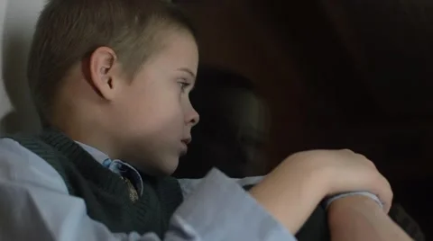 A boy sits on a window Stock Footage 57461649