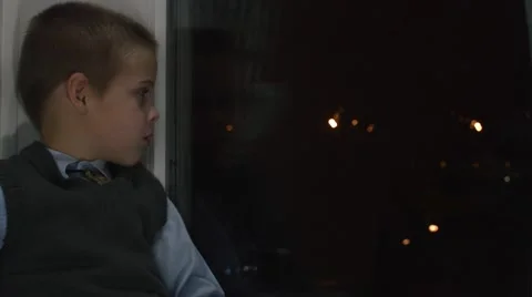 A boy sits on a window Stock Footage 57461708