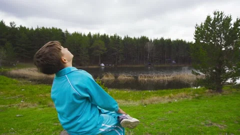Boy sitting against lake view. Stock-Footage 198936749