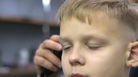 Boy is sitting in the barber shop Stock-Footage 149677478