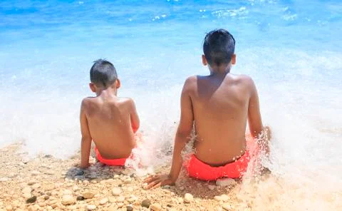 Boy sitting on the beach Foto stock