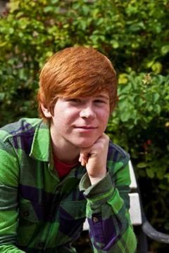 Boy sitting on a bench Stock Photos