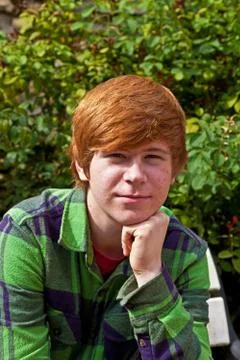 Boy sitting on a bench Stock Photos