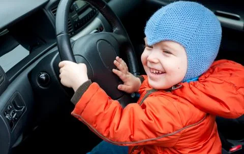 Boy sitting in the car as the driver 写真素材