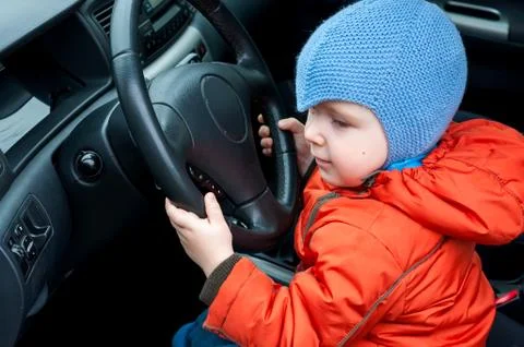 Boy sitting in the car as the driver Stock Photos