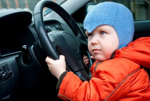 Boy sitting in the car as the driver Stock-Fotos