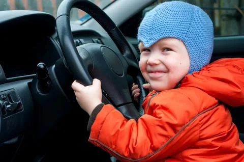 Boy sitting in the car as the driver 写真素材