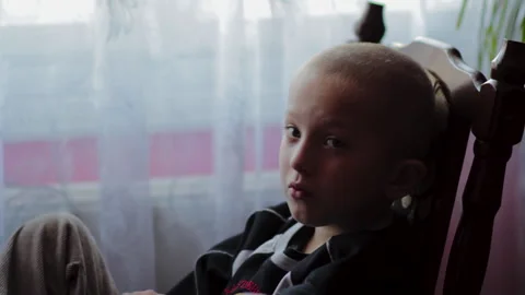 Boy is sitting on a chair Stock Footage 201677788