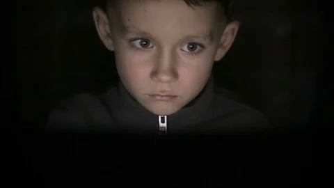 The boy is sitting in the dark at the computer Stock Footage 71903540