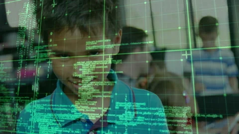 Boy sitting at desk tapping tablet and activating green code grid enhancing Stock Footage 316185129