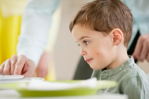 Boy sitting at a dining table Stock Photos