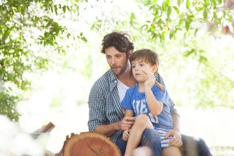Boy sitting on father's lap Stock Photos