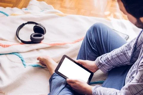 Boy sitting on the floor with tablet Stock Photos