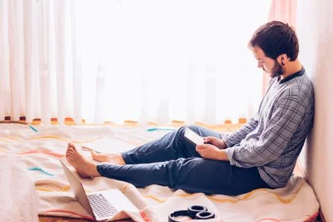 Boy sitting on the floor with tablet Stock Photos