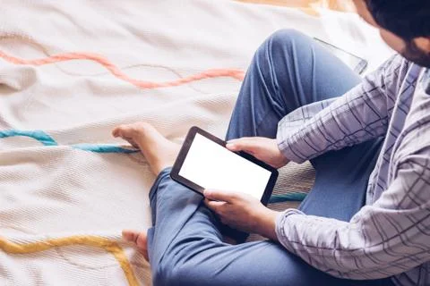 Boy sitting on the floor with tablet Stock Photos
