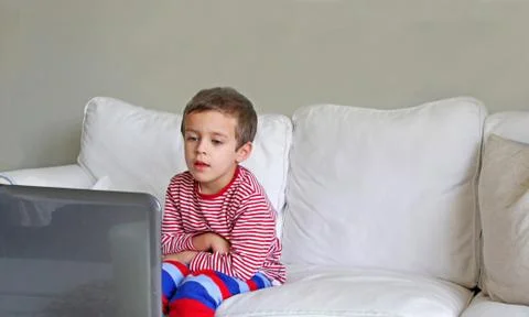 Boy sitting in front of computer Stock Photos