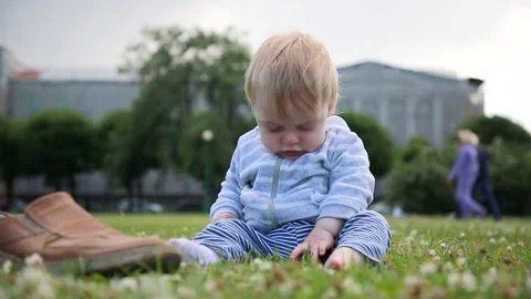 The boy is sitting on the grass Video stock 134734954