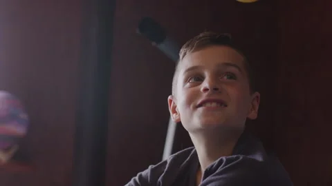 Boy sitting in his bed and looking up Stock Footage 264281695
